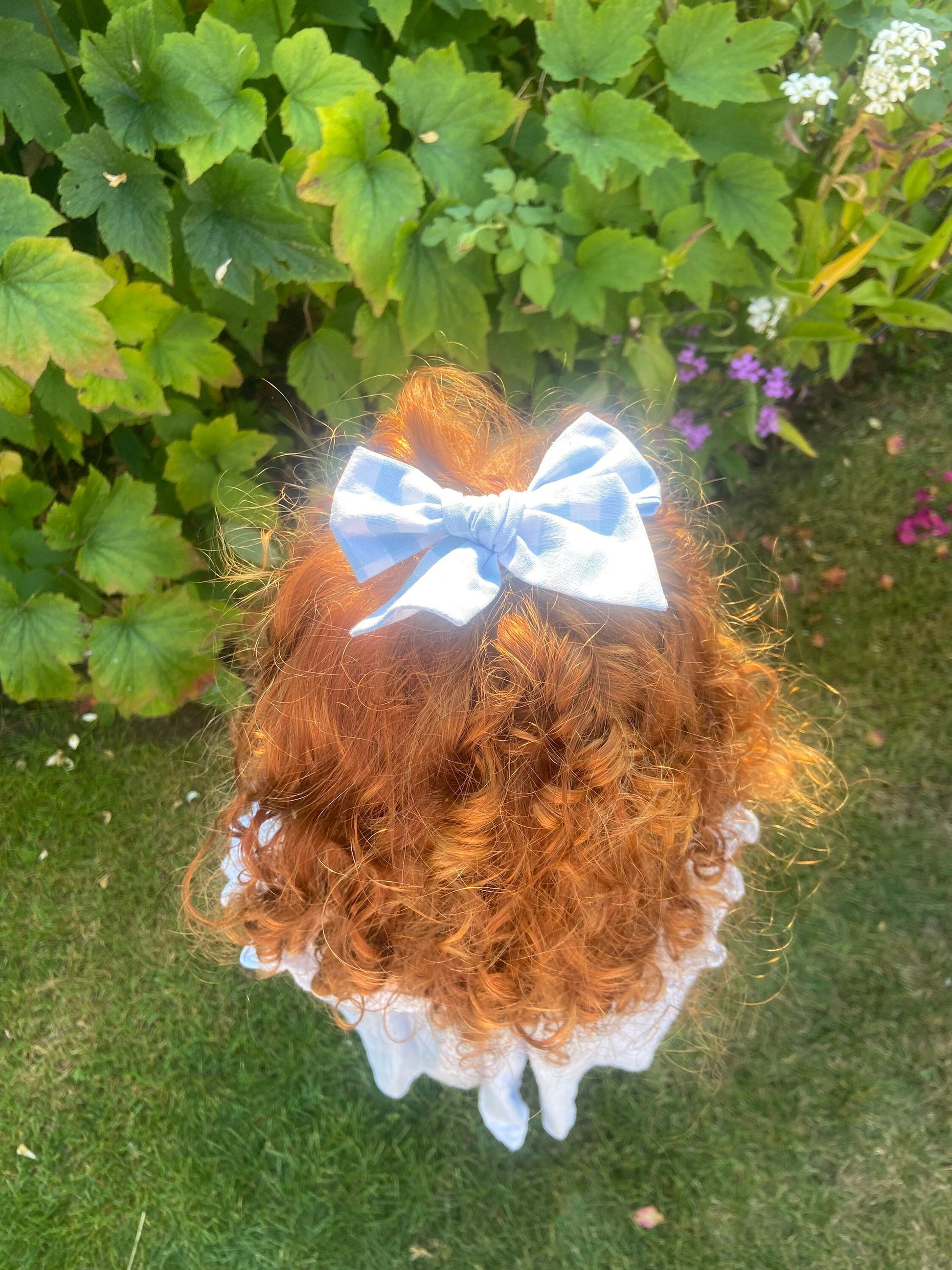 Blue fabric gingham bow, ideal for a girls birthday present. You can either choose a clip or bobble for your bow.