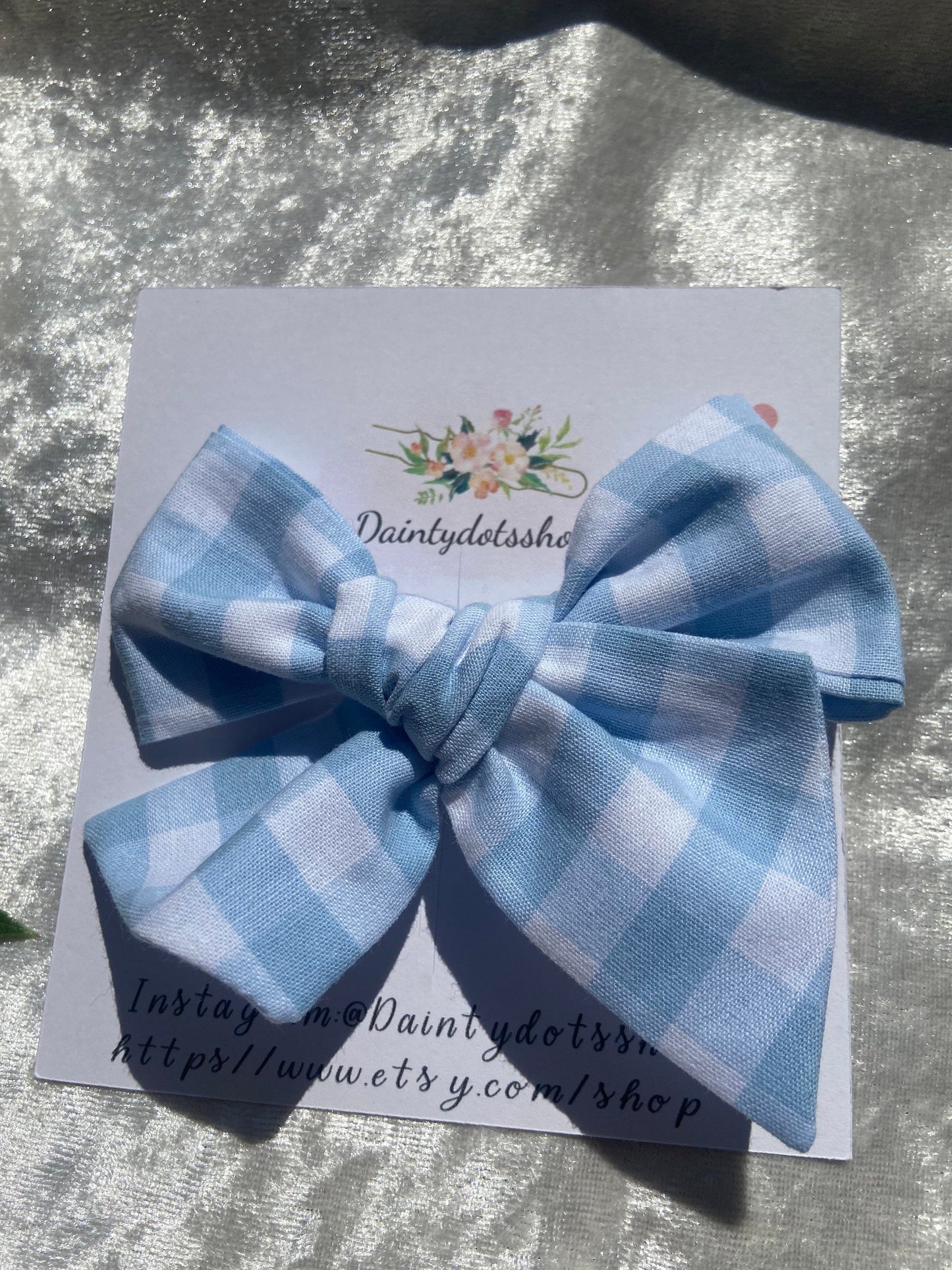Blue fabric gingham bow, ideal for a girls birthday present. You can either choose a clip or bobble for your bow.