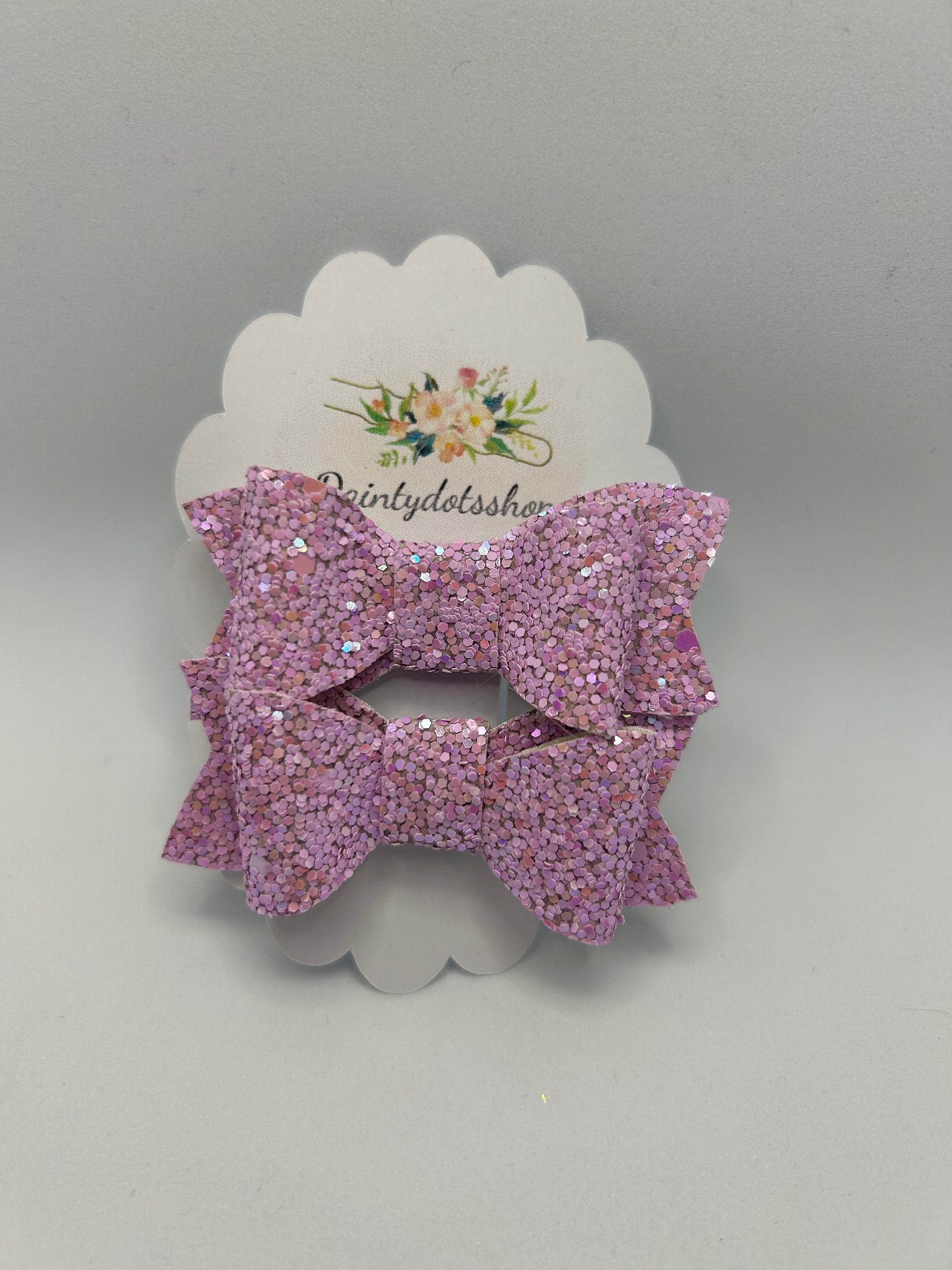 A pair of lilac frost glitter bows ideal as a gift or stocking filler.
